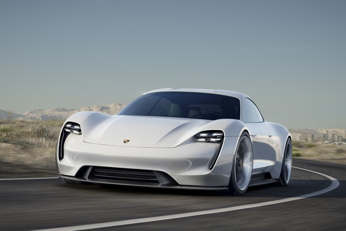 White Porsche Mission E Concept driving on a road