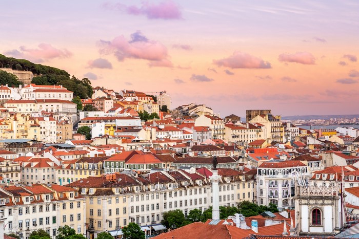Lisbon cityscape with traditional houses and sunset sky