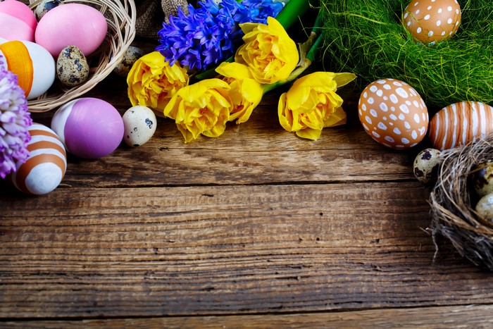 Easter eggs and flowers on wooden table