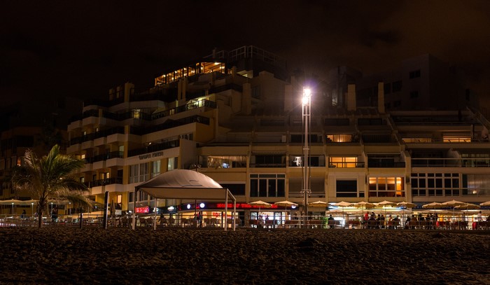 Night view of buildings and beach cafes in Las Palmas, Gran Canaria