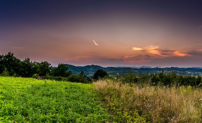 Sunset over rolling hills and fields
