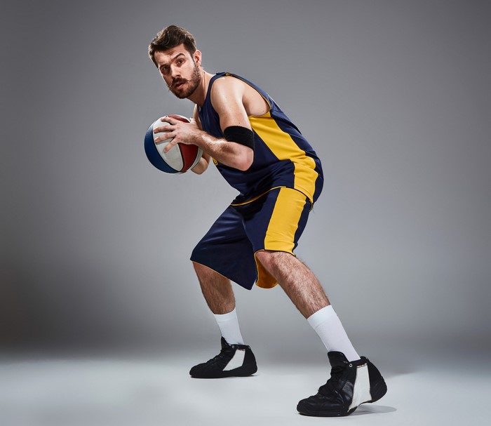 Man in basketball uniform holding a ball