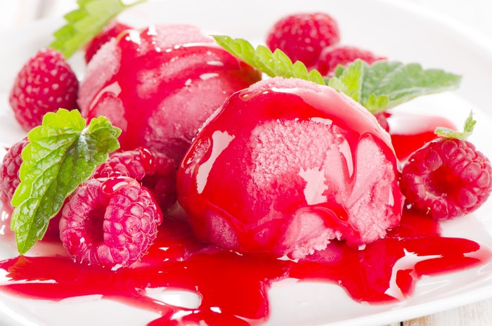Raspberry ice cream with fresh raspberries and mint