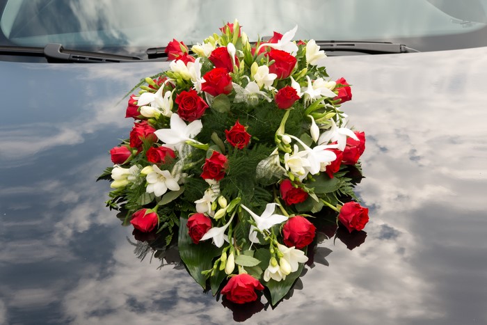Bouquet of Red Roses and White Freesia on a Car
