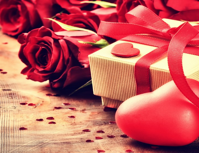 Red roses and gift box with red ribbon and hearts