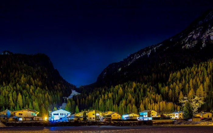 Houses in a mountain valley at night