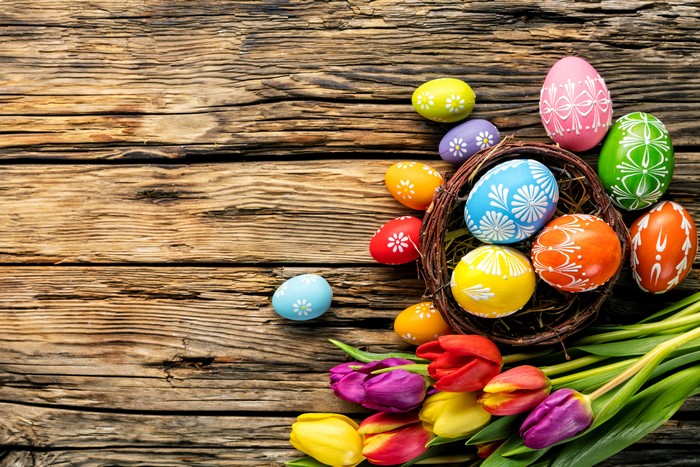 Easter Eggs and Tulips on Wooden Background