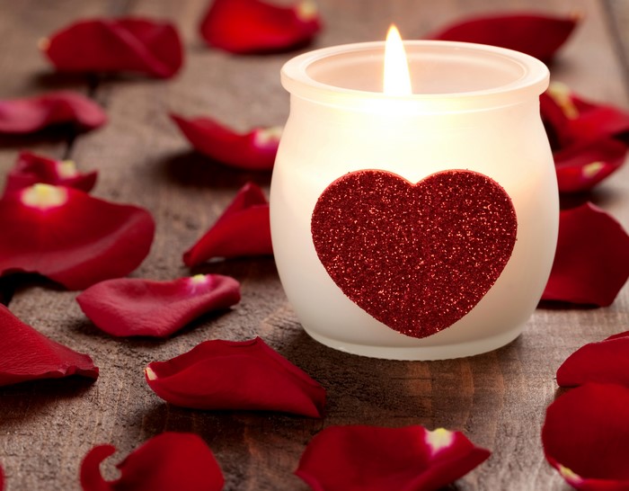 Candle with heart and rose petals