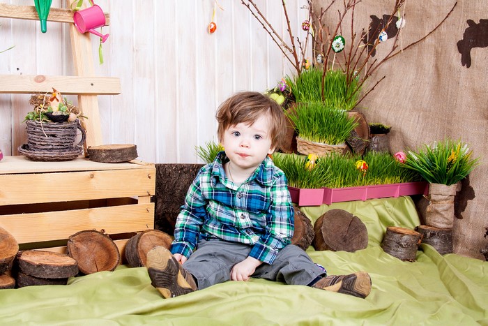 Toddler boy in plaid shirt sitting for Easter photoshoot