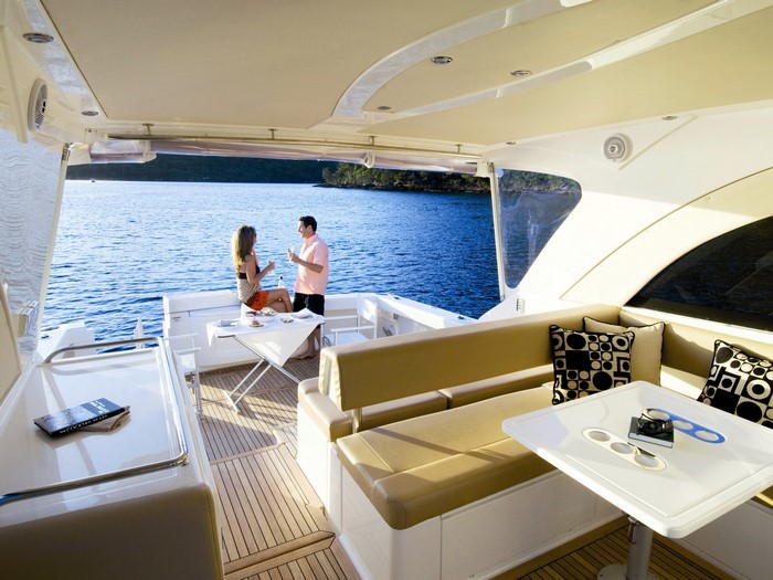 Couple enjoying drinks on a yacht deck