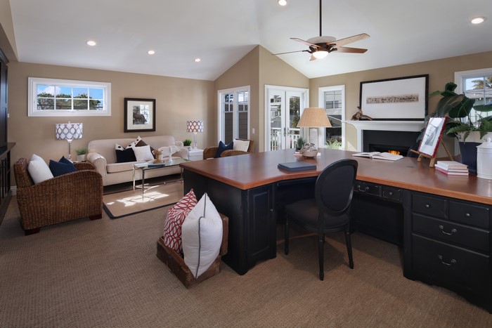Home office with sofa, armchair, and desk