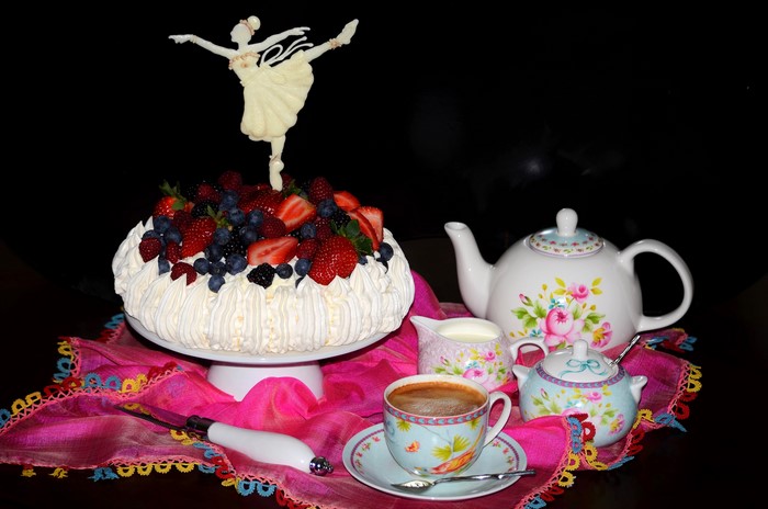 Pavlova cake with berries and tea set