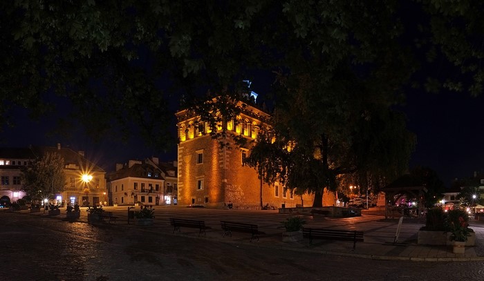 Old town square at night with illuminated building