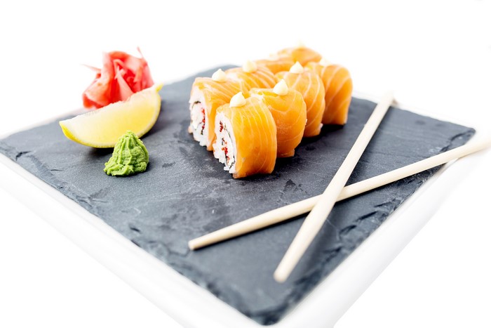 Salmon sushi rolls with lemon and wasabi