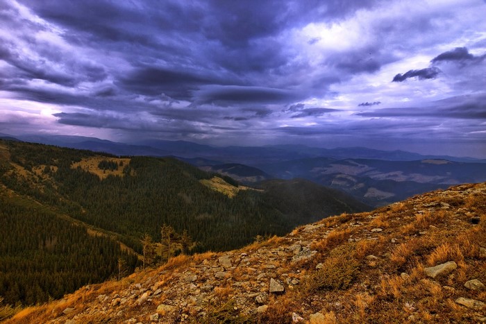 Mountain landscape with dark clouds over forests in Ukraine
