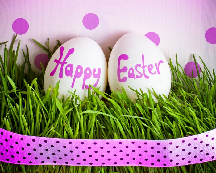 Easter eggs with Happy Easter text on grass