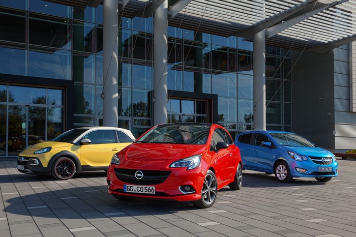 Three Opel Cars in Front of a Modern Building