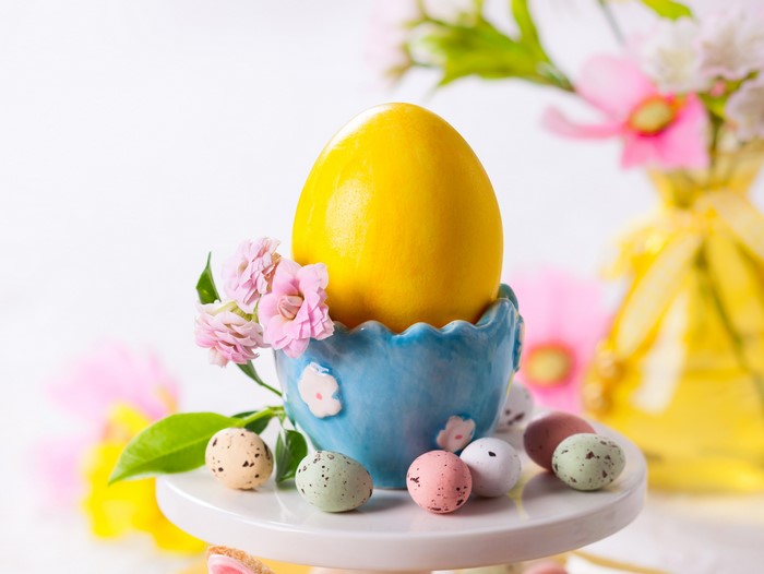 Easter eggs and flowers on a cake stand