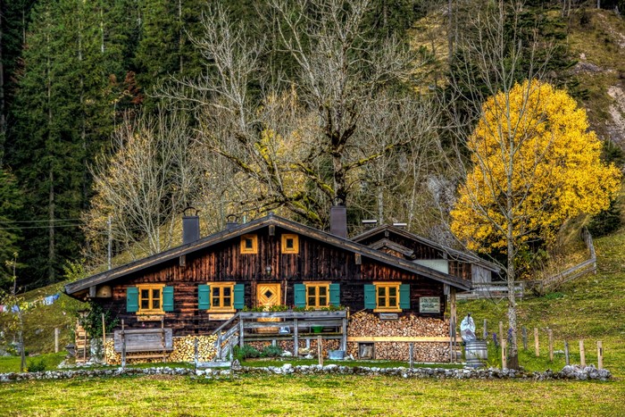 Wooden houses with stacked firewood in Brannenburg, Germany