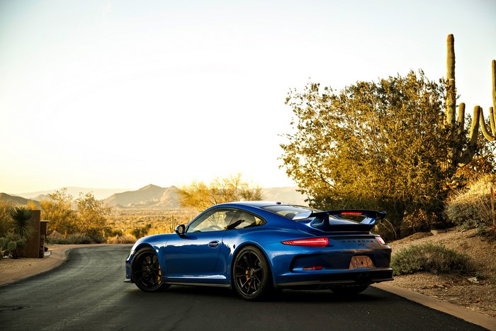 Blue Porsche 911 GT3 in a desert landscape