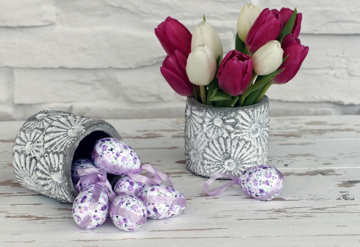 Easter tulips and eggs in decorative vases
