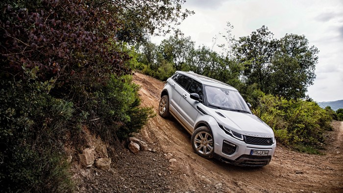White Land Rover Evoque driving on a dirt road
