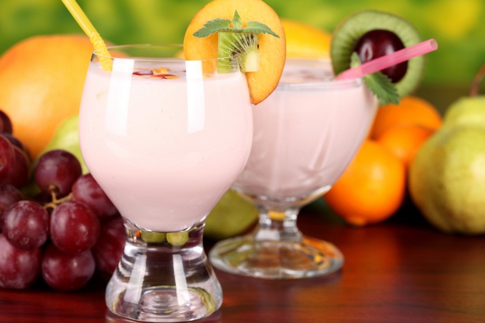 Fruit drinks with grapes, oranges, pears, and kiwi