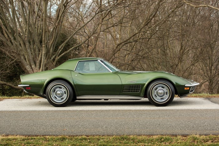 Green Chevrolet Corvette Stingray parked on a road