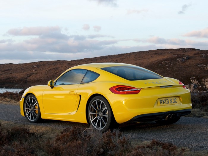 Yellow Porsche Cayman S on a road