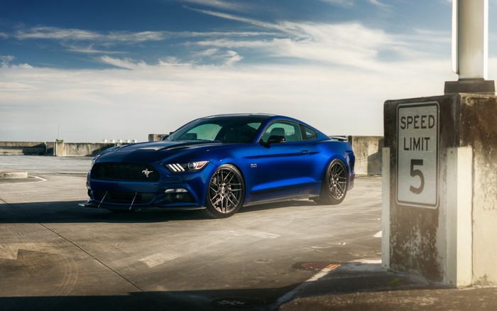 Blue Ford Mustang GT on a rooftop parking lot