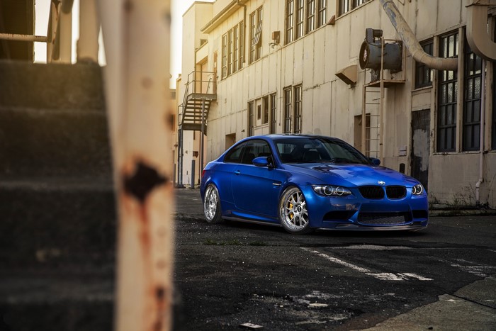 Blue BMW M3 E92 parked in an industrial alley