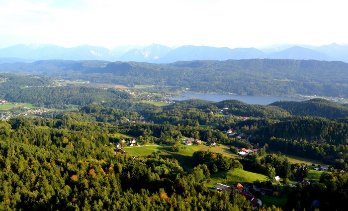 Panoramic view of a lake and forested hills in Slovenia