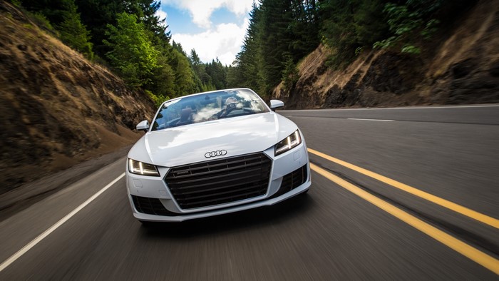 White Audi TT Roadster TFSI quattro US-spec driving on road