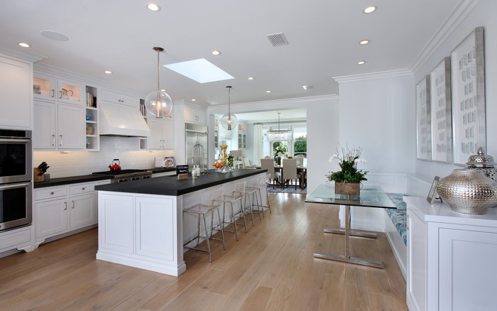 Modern white kitchen with island and dining area
