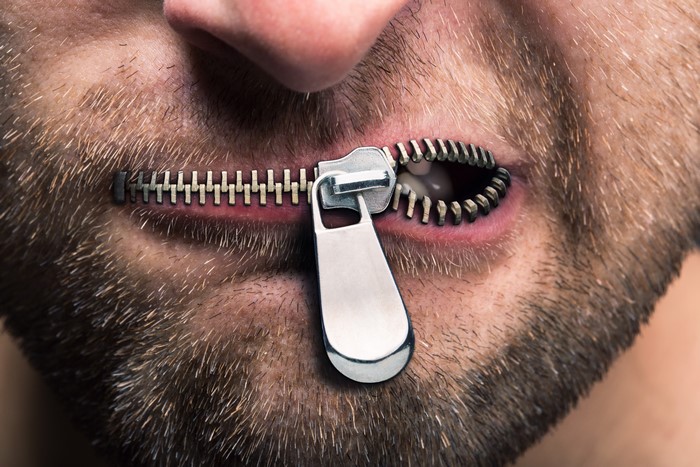 Man with zipper over mouth