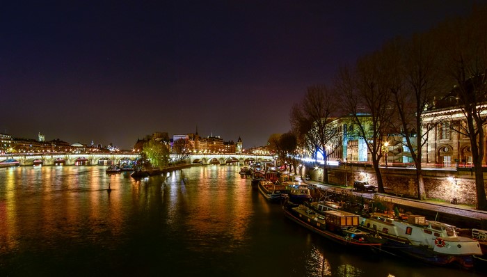 Parisian River Seine at Night with Bridges and Boats