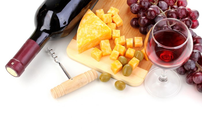 Wine bottle, cheese, grapes, and wine glass