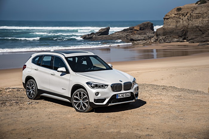 White 2015 BMW X1 xDrive xLine F48 on a Beach