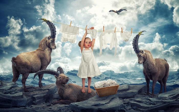 Girl hanging laundry with ibexes and eagle