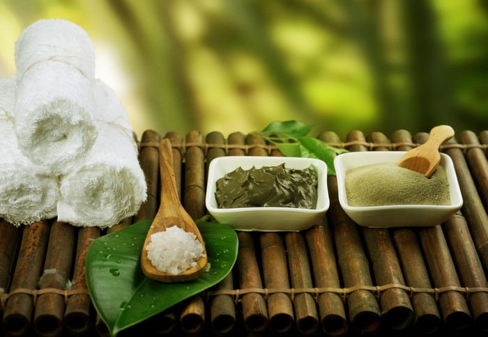 Spa towels and spa ingredients on bamboo mat