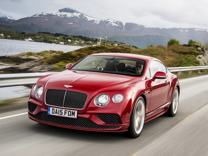 Red 2015 Bentley Continental GT driving on a road