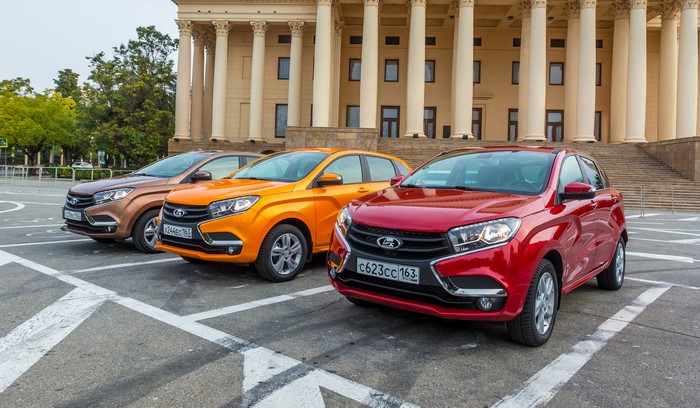 Three Lada XRAY cars parked in front of a building