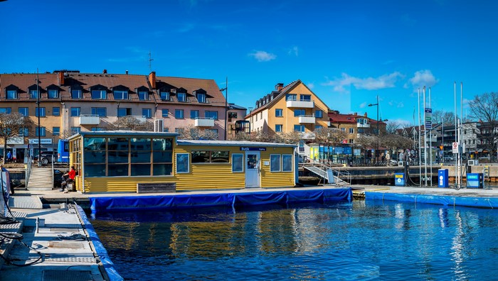 Vaxholm, Sweden marina with yellow building and houses