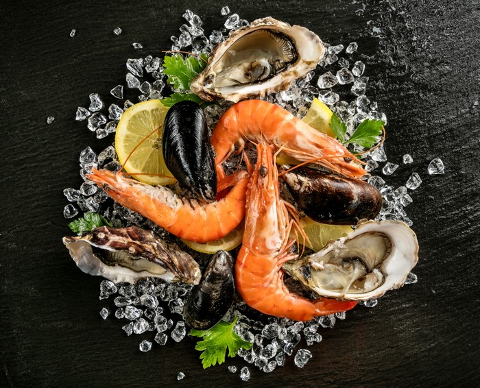 Seafood platter with shrimp, oysters, and mussels on ice