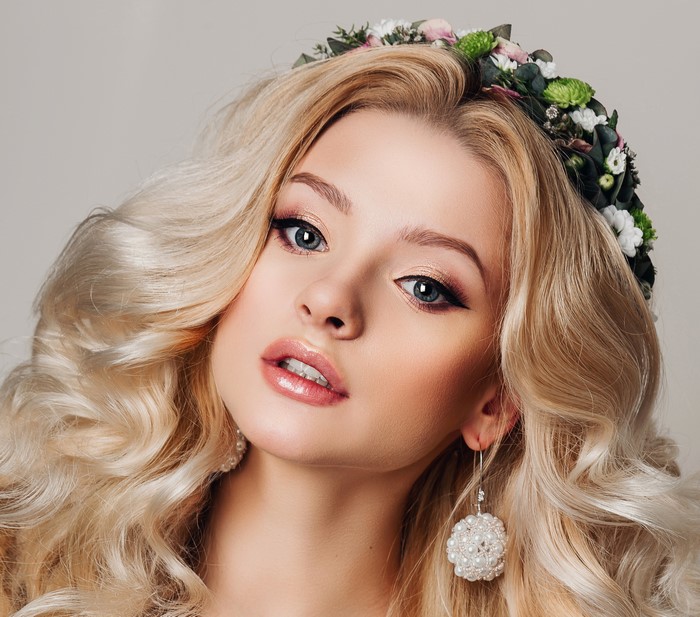Blonde woman with flower crown and pearl earrings