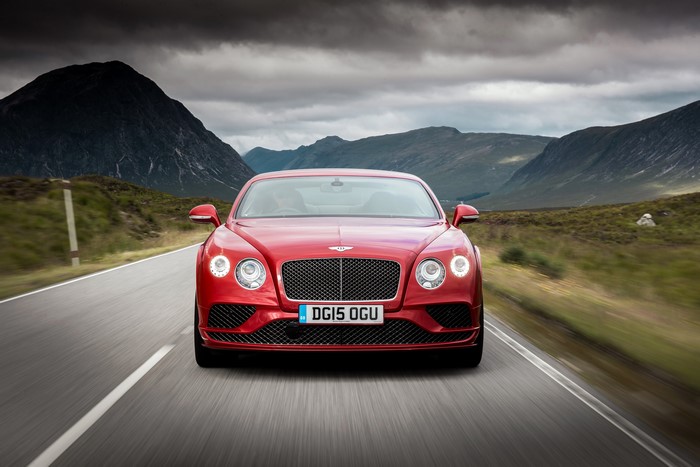 Red 2015 Bentley Continental GT driving on road