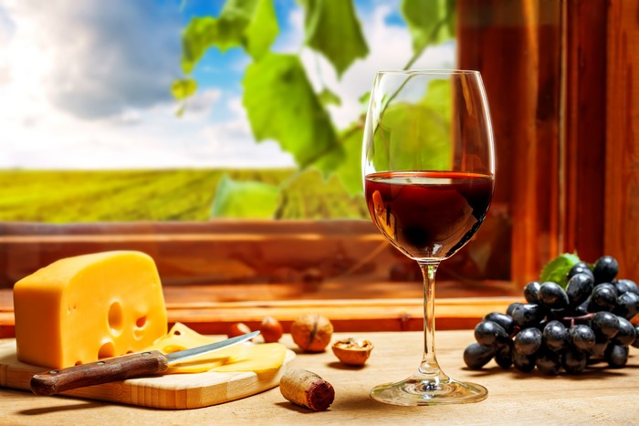 Wine, Grapes, and Cheese on a Table
