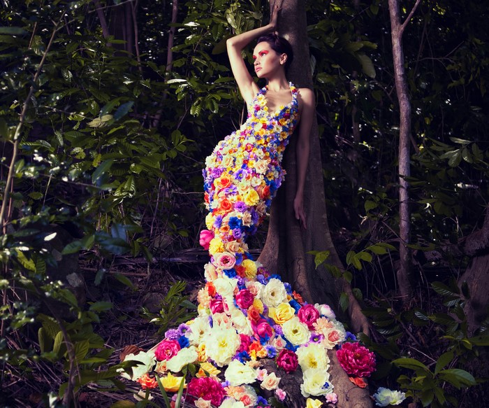Woman in floral dress in forest