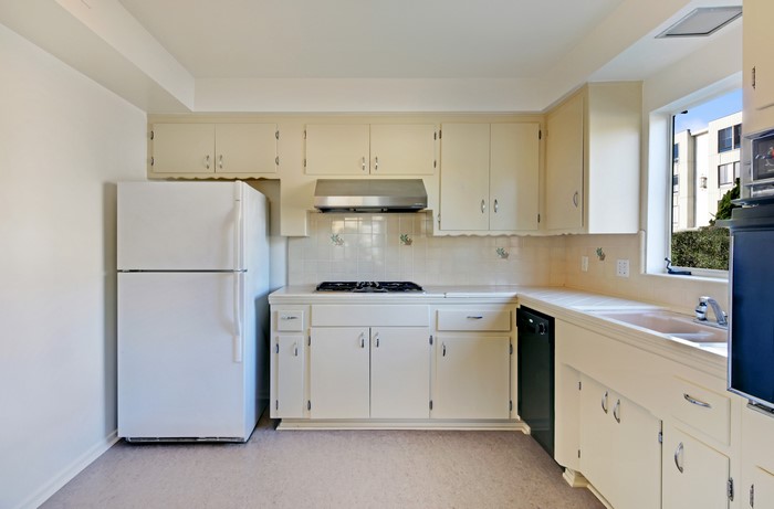 Interior of a cream-colored kitchen with white appliances