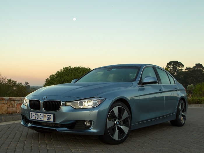 BMW ActiveHybrid 3 sedan on paved surface at dusk
